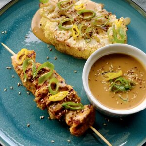 Baked cauliflower with chicken satay and tahini dressing.