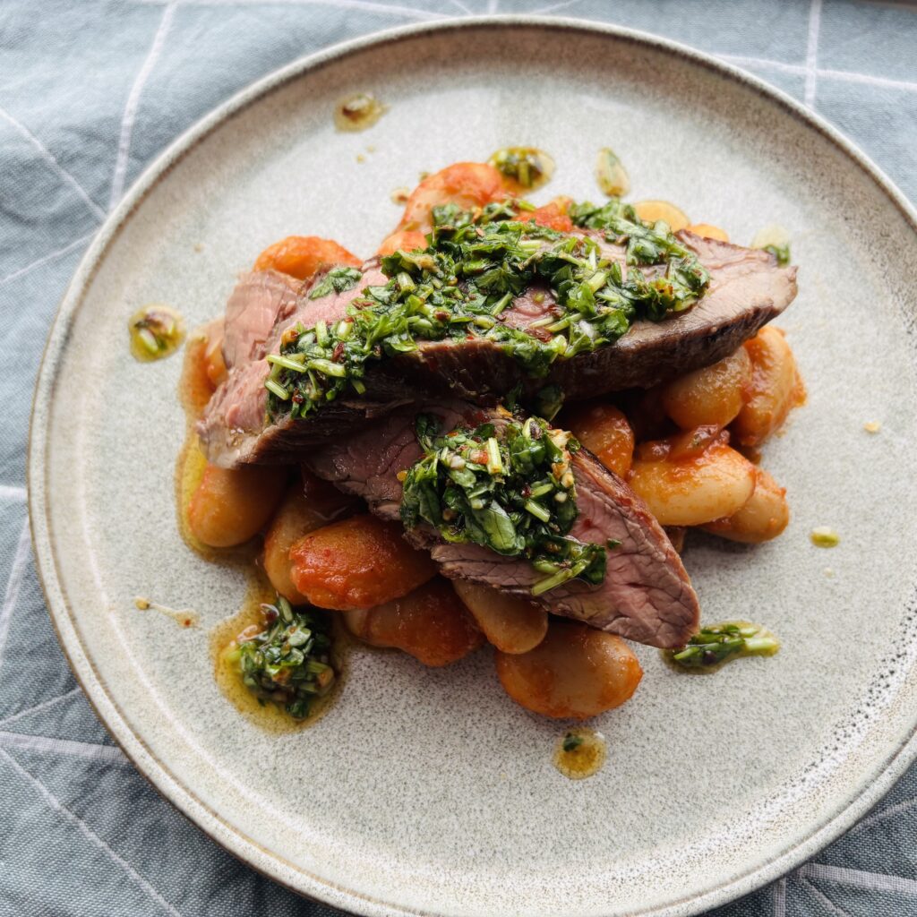 Flank Steak served with Butter Beans and Chimichurri